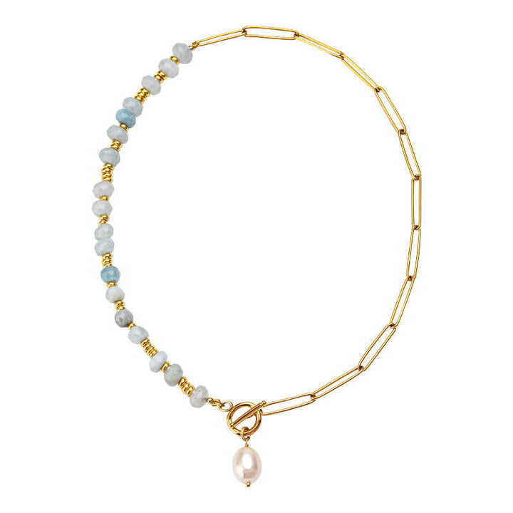 Zoé – Dlouhé zlaté náušnice s perlovým přívěskem.